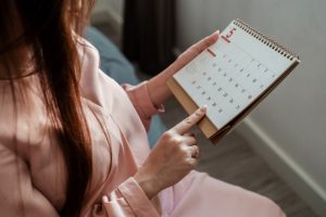 Woman looking at calendar making advance plans