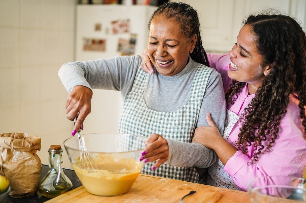 Younger woman and her second mom baking together