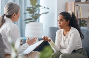 Young woman talking with grief therapist