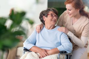 older woman being cared for by a young nurse