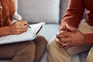 Husband and wife sitting together, writing down their wishes; reviewing checklist