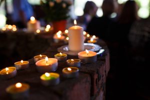 Row of candles lit at a funeral