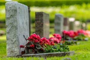 Row of gravestones with flowers at a cemetery