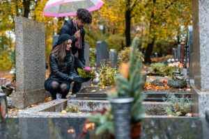Man and woman visiting the grave of a loved one