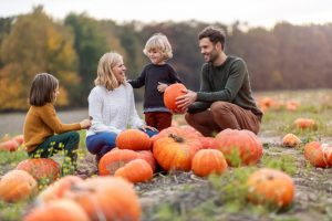 Family with kids at a pumpkin patch