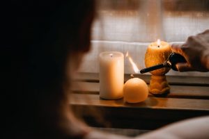 Woman lighting memorial candles in her home