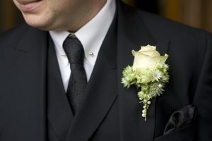 man wearing a nice suit to a funeral