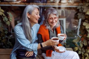 two older women drinking coffee together