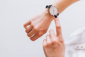 woman pointing at a watch on her wrist