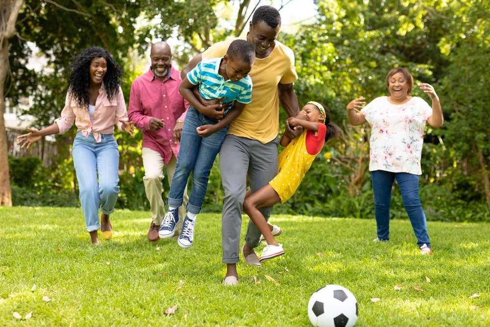 multigenerational family playing soccer together