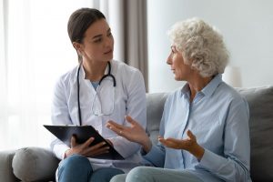 Mature woman talking with her doctor about her medical preferences