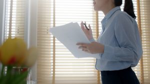 Woman standing in front of mirror practicing speech