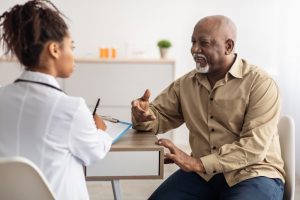 Man sitting down with this doctor, talking together