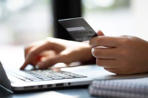 Person using technology to pay online with a credit card