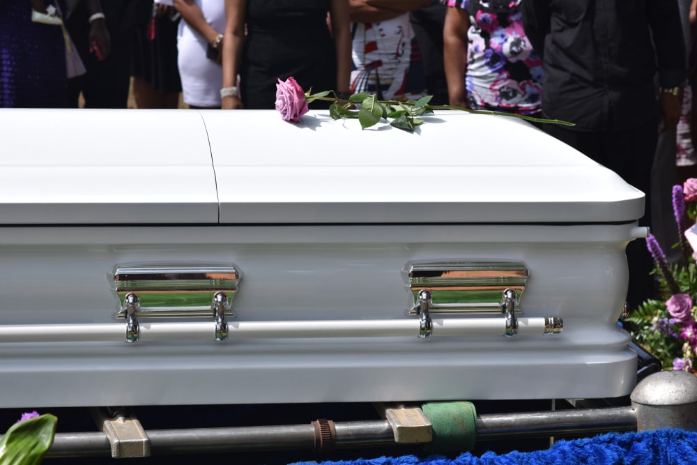white metal casket sitting outside