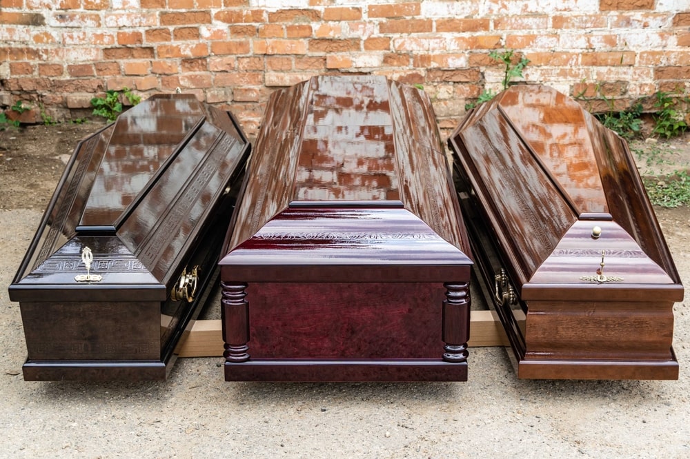 coffins and caskets sitting side by side