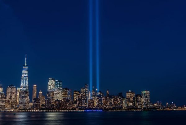 NYC night skyline with two lights lighting the sky in place of the Twin Towers