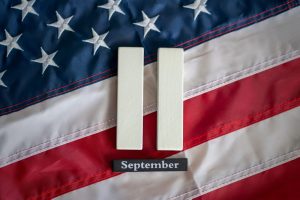 Blocks saying "September 11" laid out on top of American flag