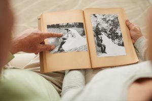 Two people looking at a photo album and sharing memories and stories