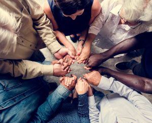 People of different backgrounds and ethnicities holding hands in solidarity