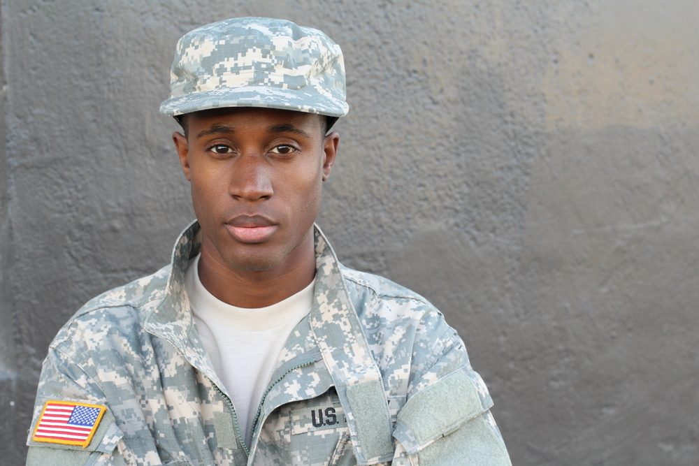 African American soldier staring solemnly toward the camera