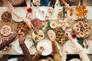 Six friends getting together for a holiday brunch, lots of food, looking down from above