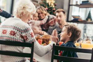 Grandmother surrounded by her children and grand-children at Christmas