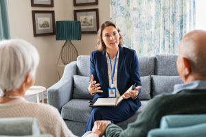Mature couple sitting at home with an attorney as they discuss policies