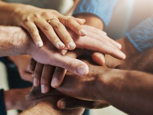 Stacked hands representing community