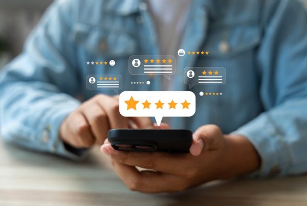 Person sitting down and looking at online review on a smartphone