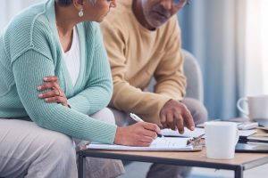 Couple sitting at home and deciding what plans to make for a funeral