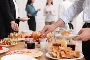 A gathering around a buffet meal with several guests