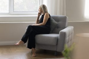 Middle-aged woman sitting quietly at home in an armchair