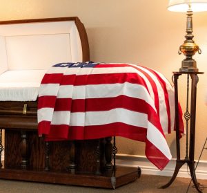 A casket draped with an American flag at the viewing