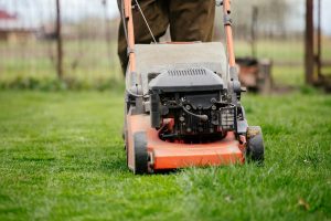 Man mowing lawn as an act of service for a grieving friend