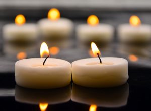 Votive candles burning in memory of a loved one