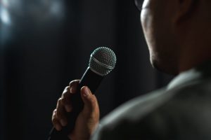 Man speaking into microphone as he delivers eulogy