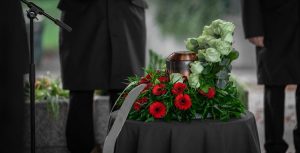 Cremation urn surrounded by white and red flowers