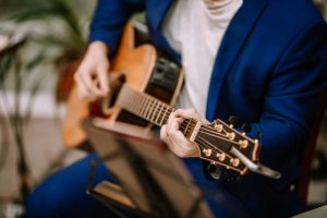 Man in suit playing guitar