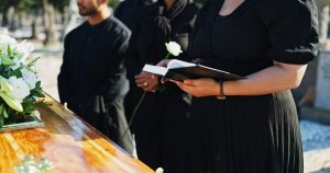 Woman reading from a book at the graveside service