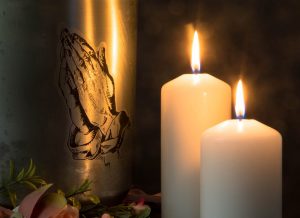 Urn with praying hands etched into the material