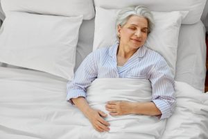 Senior adult woman sleeping peacefully in bed