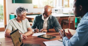 Husband and wife chatting with advisor about putting their affairs in order