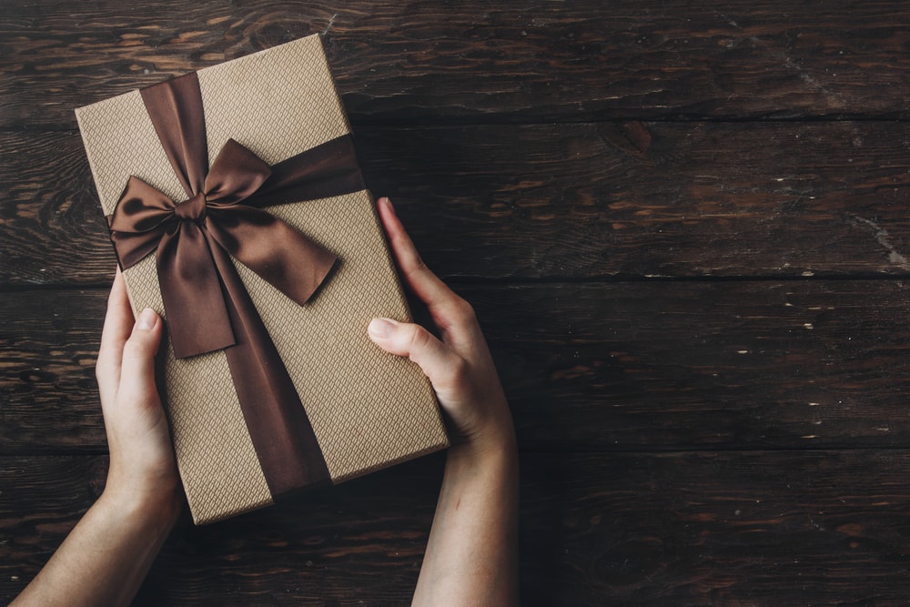 Creative sympathy gifts: package wrapped in beige paper with chocolate brown ribbon