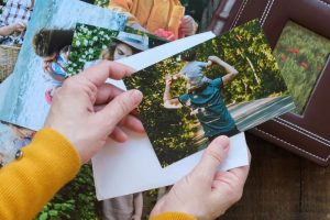 Person looking at printed family photos