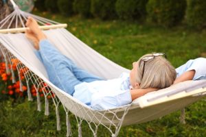 Woman resting in a hammock on a spring day