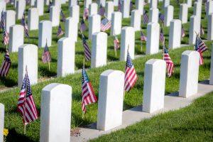 American military cemetery with white tombstones and American flags