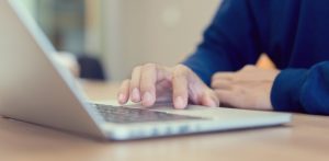 man sitting at computer