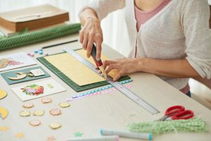 Woman creating scrapbook