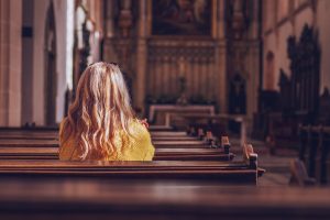 Woman sitting in church pew